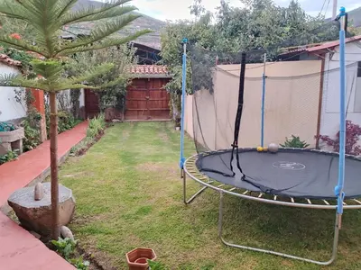 a trampoline in the backyard of a house at The yellow house in the valley in Urubamba