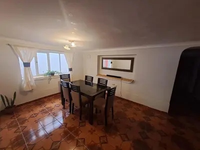 a dining room with a table and chairs at The yellow house in the valley in Urubamba
