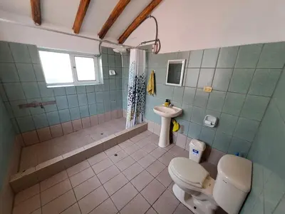 a bathroom with a toilet and a sink at The yellow house in the valley in Urubamba