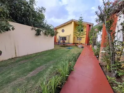 a red path in front of a house at The yellow house in the valley in Urubamba