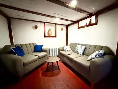 a living room with a couch and a table at Rustic House in the Heart of Cusco in Cusco