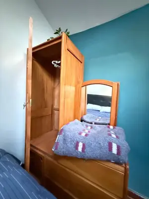 a bedroom with a wooden bunk bed with a blue wall at Rustic House in the Heart of Cusco in Cusco