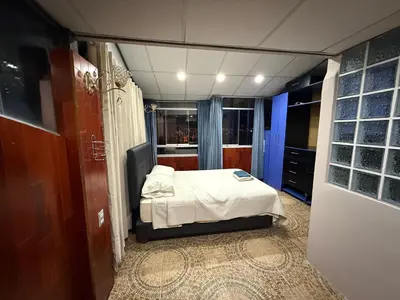 a small bedroom with a bed in a room at Rustic House in the Heart of Cusco in Cusco