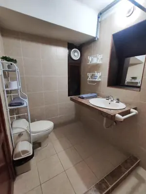 a bathroom with a toilet and a sink and a mirror at Habitación acogedora cerca a Larcomar in Lima