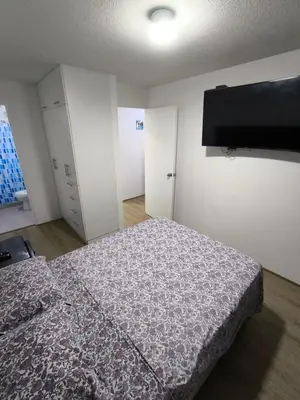 a bedroom with a bed and a flat screen tv at Come and have fun with the family in San Bartolo