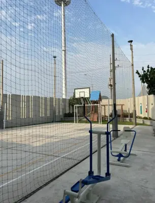 a tennis net in front of a tennis court at Come and have fun with the family in San Bartolo