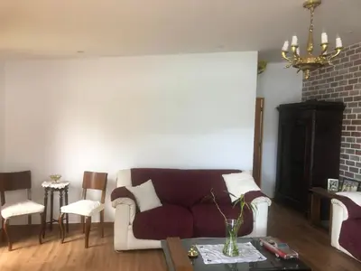 a living room with a couch and a table at Sunny refuge with large gardens in Cieneguilla