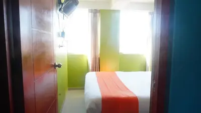 a room with a bed and a window and a door at BR Comfortable Stay Inn in Cusco