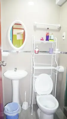 a bathroom with a toilet and a sink and a mirror at BR Comfortable Stay Inn in Cusco