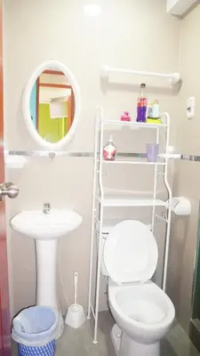 a bathroom with a white toilet and a sink at BR Comfortable Stay Inn in Cusco