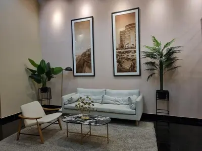 a living room with a couch and a table at Duplex con piscina en Miraflores in Lima