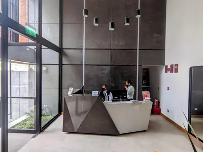two people working at a desk in an office at Stay, explore and enjoy Lima in Lima
