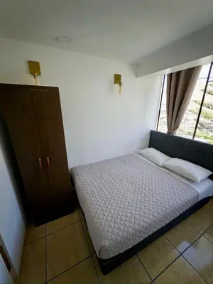 a small bedroom with a bed and a window at DEPARTAMENTO en el centro!! in Ayacucho