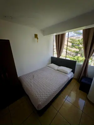 a small bed in a room with a window at DEPARTAMENTO en el centro!! in Ayacucho