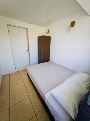 a small bedroom with a bed and a closet at DEPARTAMENTO en el centro!! in Ayacucho