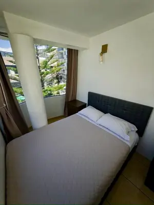 a bedroom with a bed and a large window at DEPARTAMENTO en el centro!! in Ayacucho