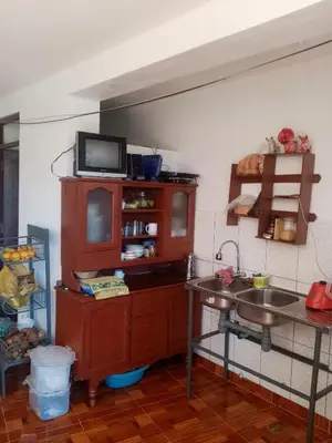 a kitchen with a sink and a counter at Hostal Aylluq Wasin - Guest House-Casa de Familia in Urubamba