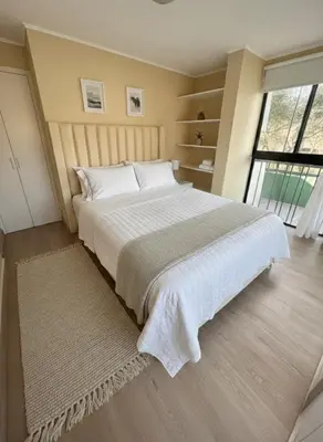 a bedroom with a large bed and a large window at Relajar y trabajar en Miraflores in Lima