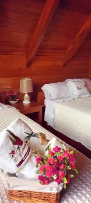 a bedroom with two beds and a basket of flowers at La Cabaña de Mary in Oxapampa
