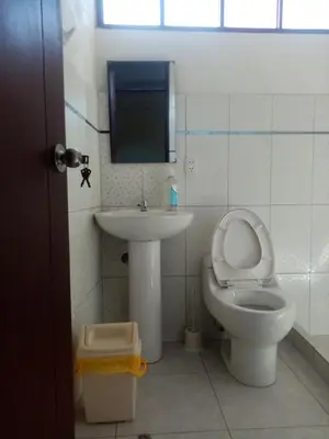a bathroom with a toilet and a sink at Hostal Aylluq Wasin - Guest House-Casa de Familia in Urubamba