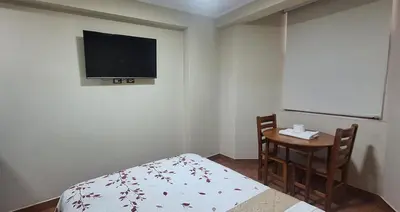 a bedroom with a bed and a table and a tv at HsDverdi in Santa María