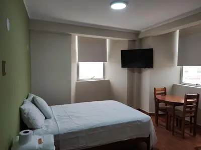 a bedroom with a bed and a table and a television at HsDverdi in Santa María