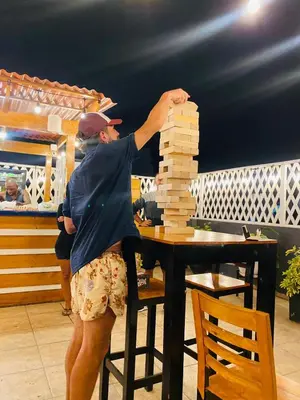 a man playing with a stack of wooden blocks at PARTY HOSTEL THAY Miraflores Lima in Lima