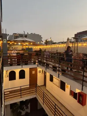 a woman standing on a deck of a boat at PARTY HOSTEL THAY Miraflores Lima in Lima