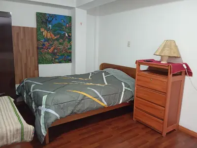 a bedroom with a bed and a lamp on a dresser at Estancia Concepción Cusco - Peru in Cusco