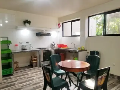 a kitchen with a table and chairs in a room at Casa Hospedaje terraza con vista a La Merced in La Merced