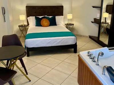 a bedroom with a bed and a bath tub at Hotel Limamar in Lima