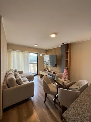 a living room with a couch and chairs and a table at Apartment in La Victoria in Lima