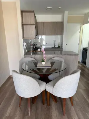 a dining room table with two chairs and a kitchen at Apartment in La Victoria in Lima