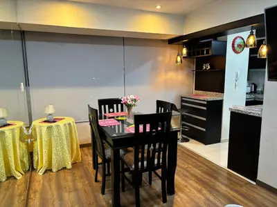 a dining room with a table and two chairs at Comfort apt in Magdalena front of supermarket! in Lima