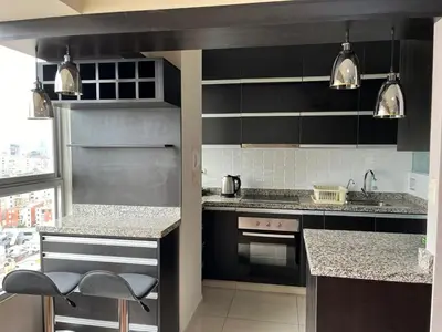 a kitchen with black and white cabinets and appliances at Comfort apt in Magdalena front of supermarket! in Lima