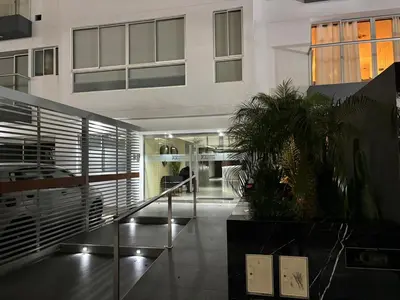 a large white building with a staircase in a lobby at Comfort apt in Magdalena front of supermarket! in Lima