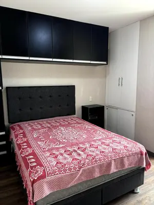 a bedroom with a bed with a red bedspread at Comfort apt in Magdalena front of supermarket! in Lima