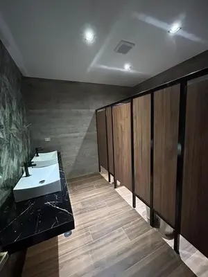 a bathroom with a sink and wooden stalls at Hotel INTERnazionale in Ayacucho