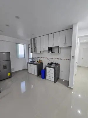 a large kitchen with white cabinets and appliances at 401 Moderno departamento equipado in Abancay