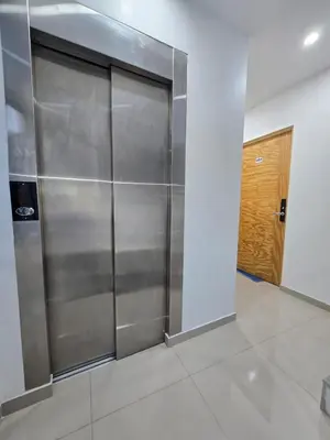a metal elevator in a room with a door at 401 Moderno departamento equipado in Abancay