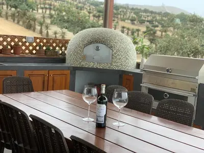 a wooden table with two wine glasses on it at Casa de campo con vista al mar in Punta Negra
