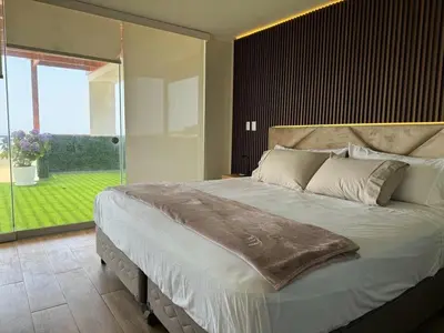 a bedroom with a large bed with a large window at Casa de campo con vista al mar in Punta Negra