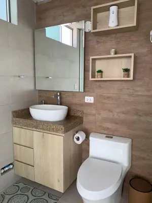a bathroom with a white toilet and a sink at Casa de campo con vista al mar in Punta Negra