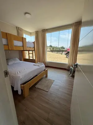 a bedroom with a bed and a large window at Casa de campo con vista al mar in Punta Negra