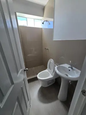 a white bathroom with a toilet and a sink at 402 Moderno departamento equipado in Abancay