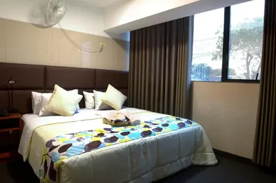 a bedroom with a bed with a teddy bear on it at Hotel Lima City in Lima