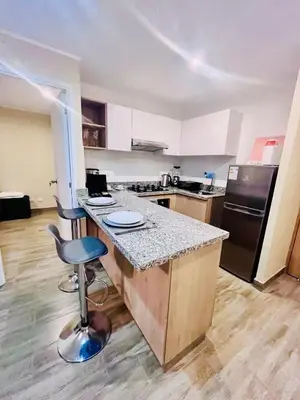 a kitchen with a counter and a bar with a stool at The Pool & City Spot - steps from Miraflores in Lima