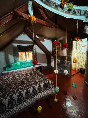 a bedroom with a bed in a attic at Hostel el molle capulichayoc in Santa Teresa