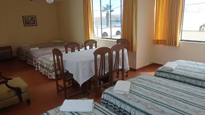 a room with four tables and chairs and a window at Hotel Perseo Inn in Barranca