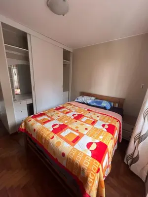 a bedroom with a bed with a colorful quilt at Comfort and family exclusivity in Lima